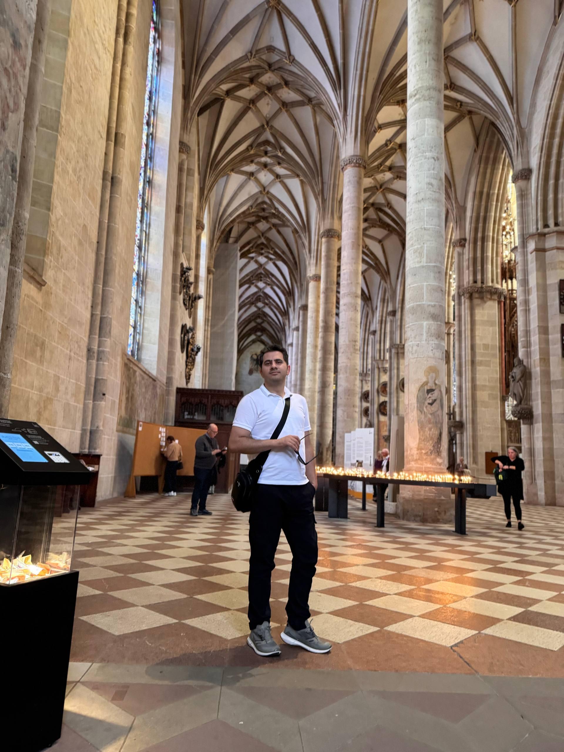 Mohammed standing inside the vaulted Gothic nave of Ulm Minster