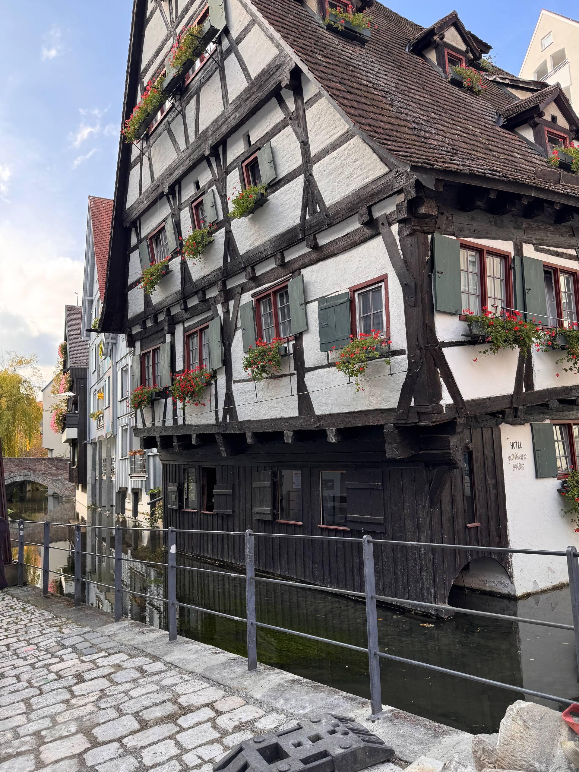The Schiefes Haus, a centuries-old crooked half-timbered hotel beside the river Blau in Ulm
