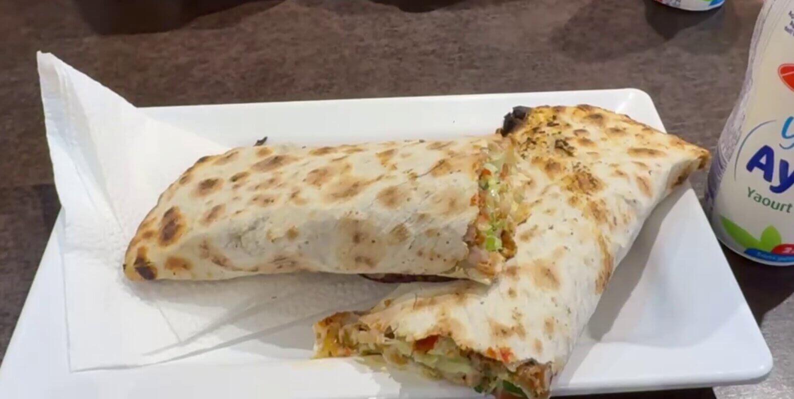 A folded lahmajun wrap on a plate at Efendy restaurant in Amsterdam