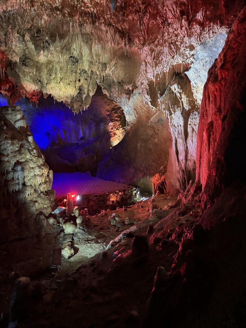 A cave chamber in the Dechenhöhle lit in dramatic blue and red tones