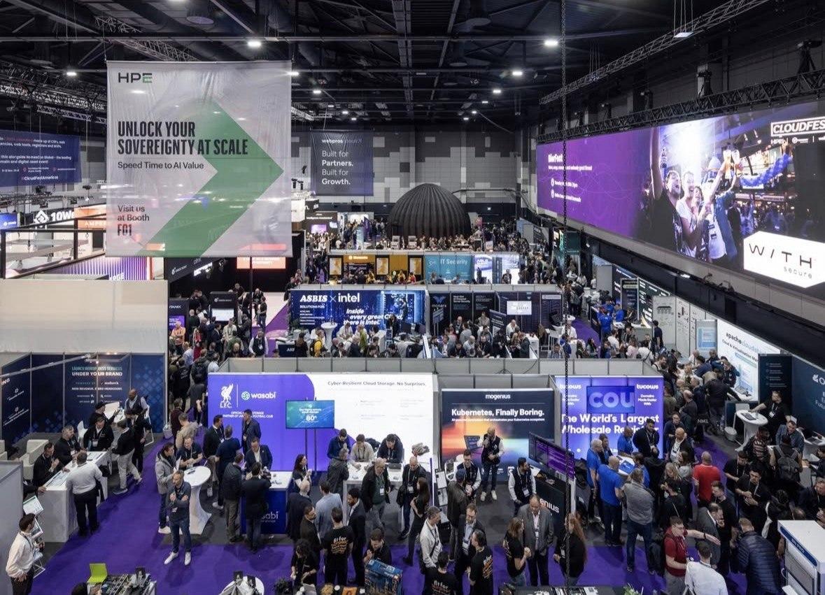 Wide view of a CloudFest exhibition hall full of vendor booths
