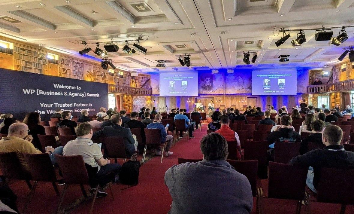 Audience watching a panel titled Coopetition in CMS at the WP Business and Agency Summit